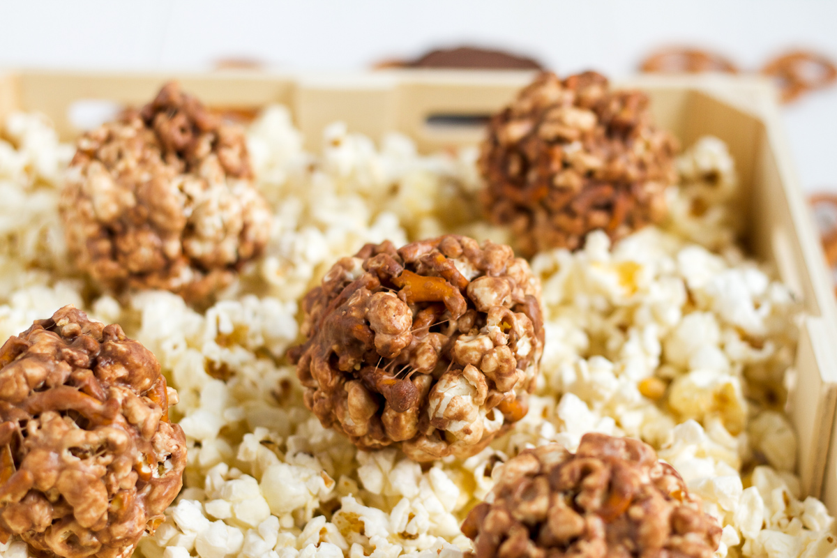 Peanut butter and pretzels fill these sweet, chocolatey popcorn balls. Make them for Halloween!