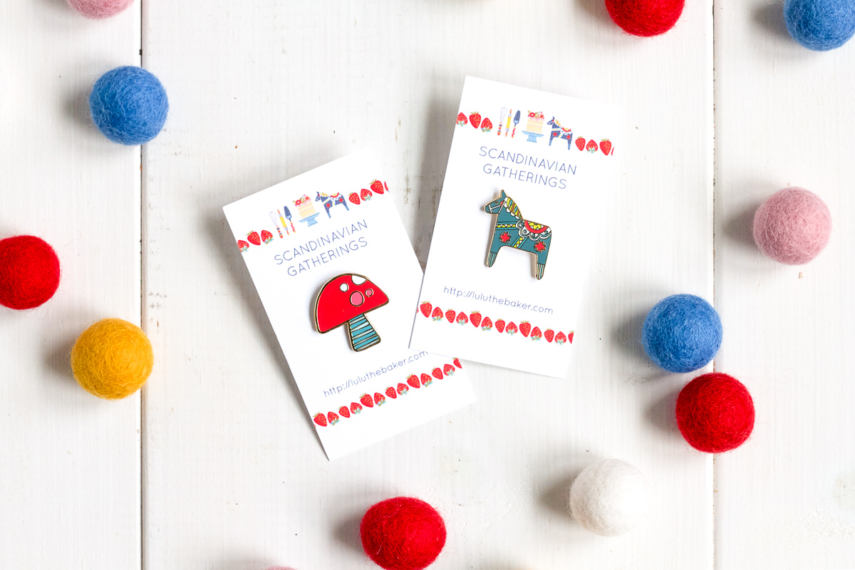 Toadstool and Dala Horse enamel pins, available from Lulu the Baker's Etsy shop