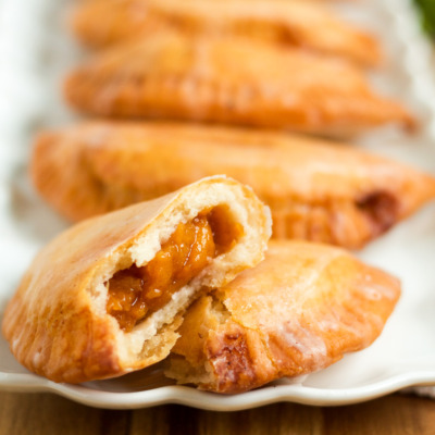 These delicious fried hand pies are filled with homemade peach jam, and are topped with a sweet, sugary glaze!