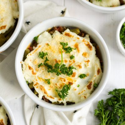 Shepherd's pie is one of my family's favorite easy dinners. These individual italian-style shepherd's pies have a delicious filling with herbs and tomatoes, and a sprinkling of parmesan cheese on top.