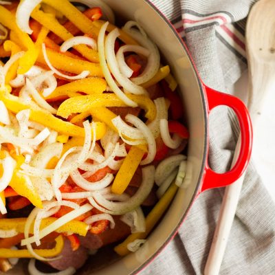 Tomato -braised sausage sandwiches with onions and peppers