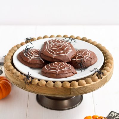Deliciously cakey chocolate cookies dipped in a rich, homemade chocolate glaze and decorated with white icing spider webs. Perfect for Halloween!