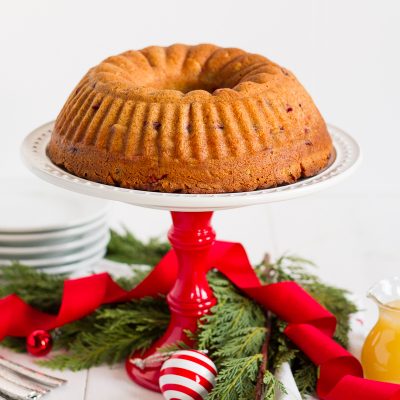 This fresh cranberry cake with hot butter sauce is simple and delicious. It is a breeze to make, but it looks beautiful and tastes luxurious. All of those things combine to make it the perfect dessert to serve to guests during the holidays.